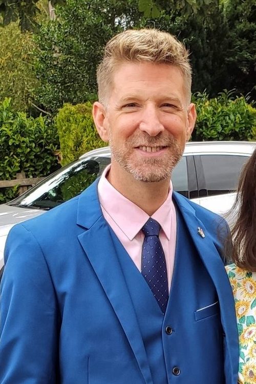 Adrian in a blue suit